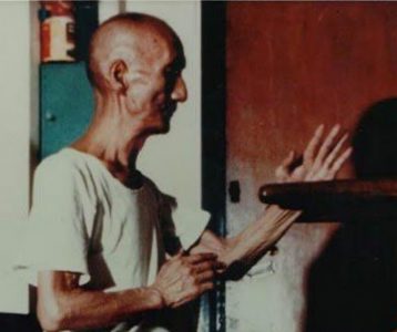 A Wing Chun practitioner demonstrating Pak Sao, the slapping block, on the wooden dummy